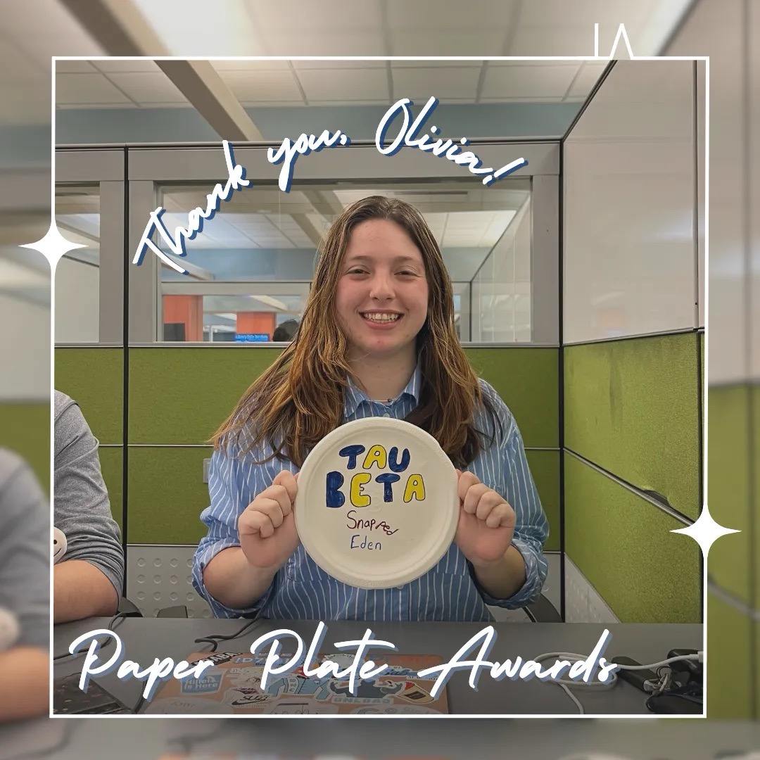 Picture of a Tau Beta Sigma member holding a paper plate against a green background